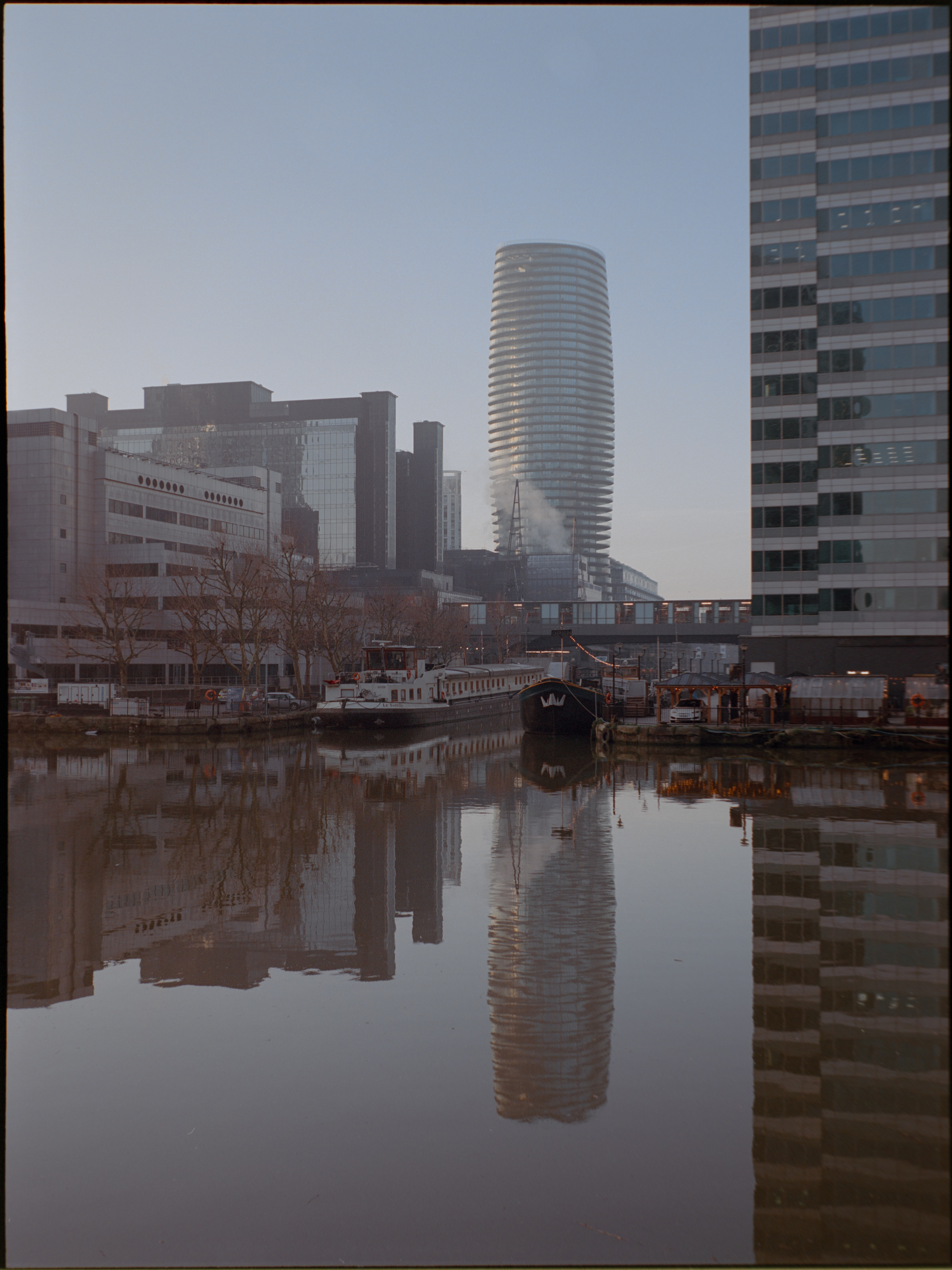 Reflective glass facade close-up in Canary Wharf — Kodak Portra 160 on Fujifilm GA645S