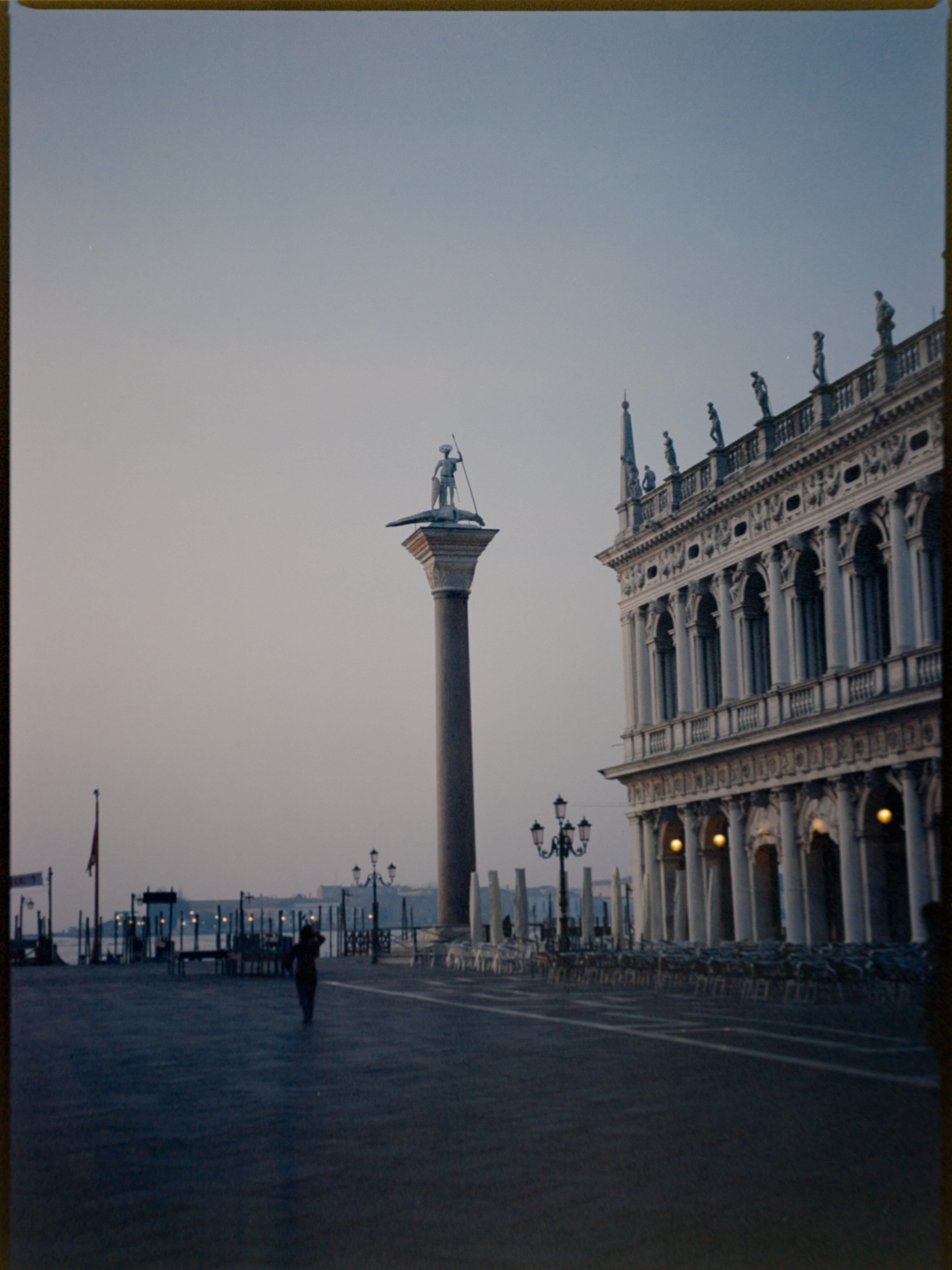 Early dawn view from the Piazzetta toward the lagoon with column silhouetted against pink sky — Ektar 100