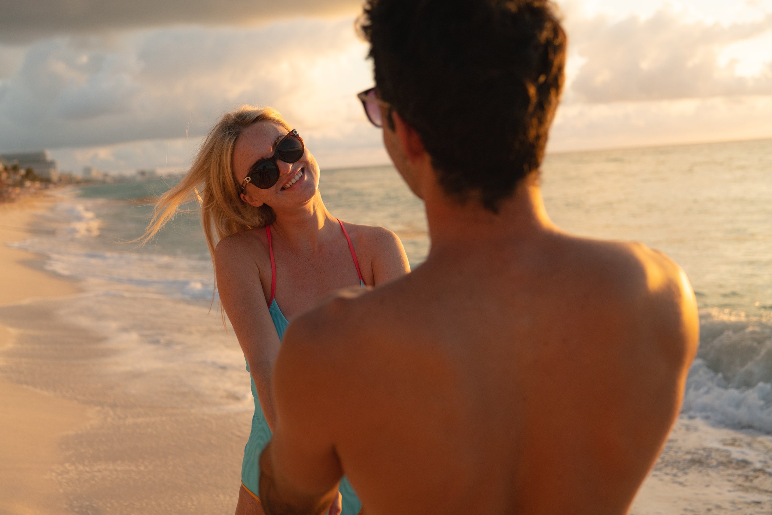 Couple beach sunset golden hour laughing Cancun resort, lifestyle photographer London