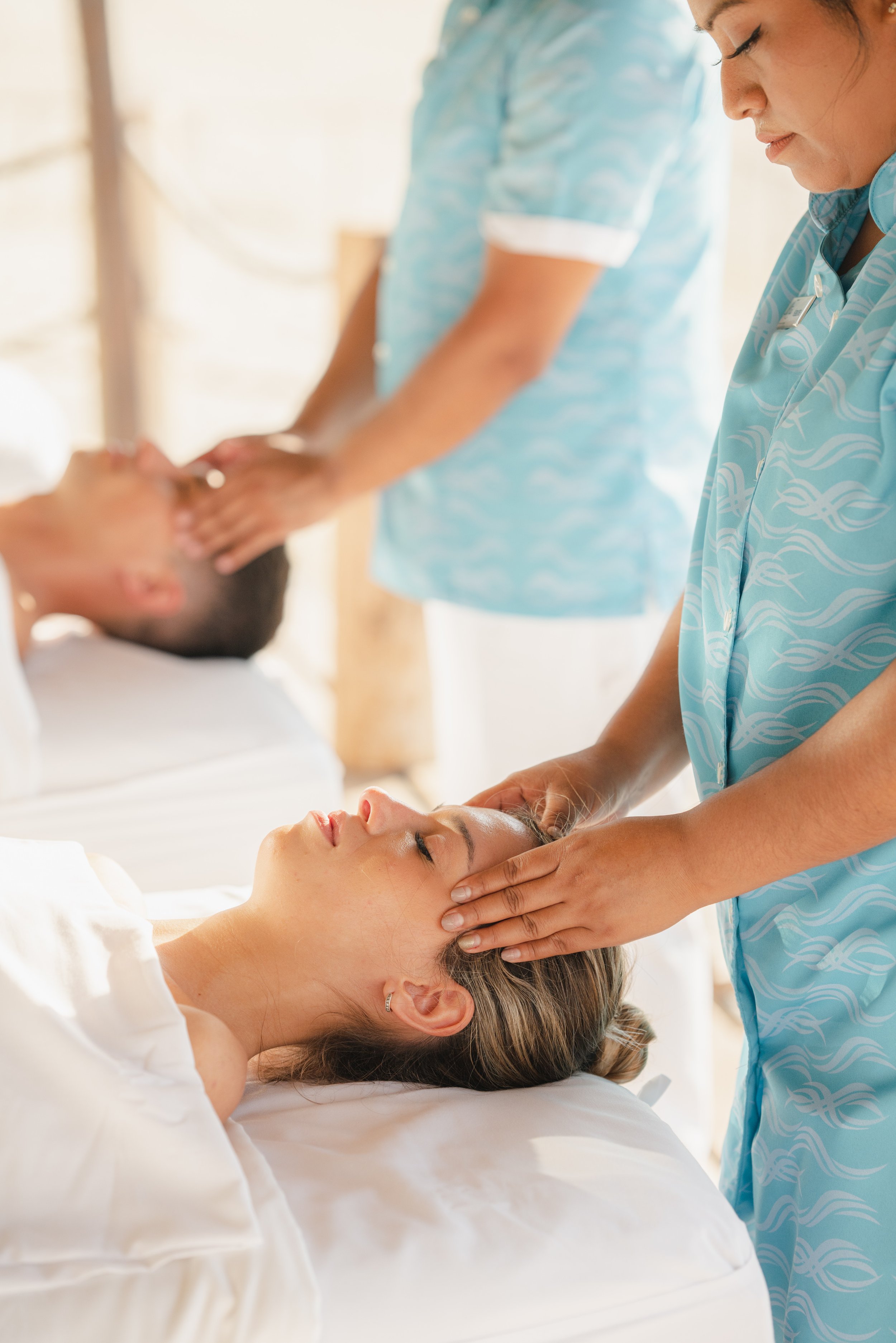 Couple receiving head massages at luxury resort spa